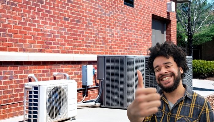 Man giving thumbs up in front of new HVAC units